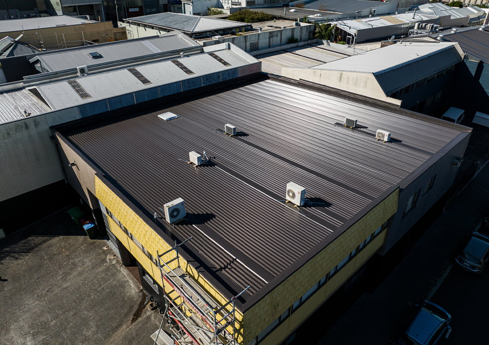 Aerial image showing a long run roof replacement on a commercial building.