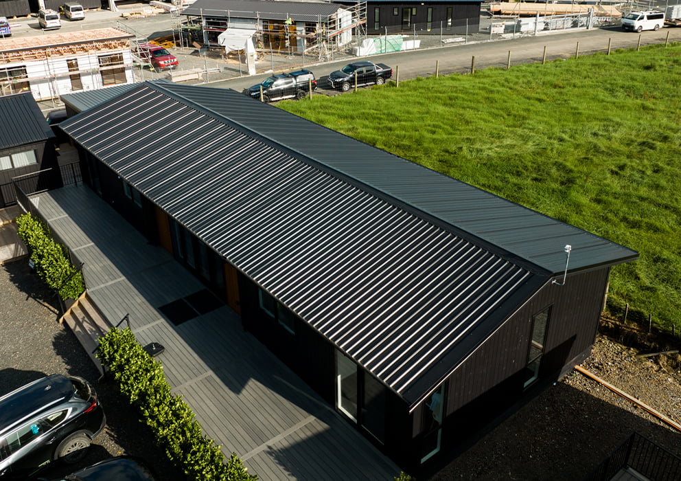 A new commercial building with black long run roofing.