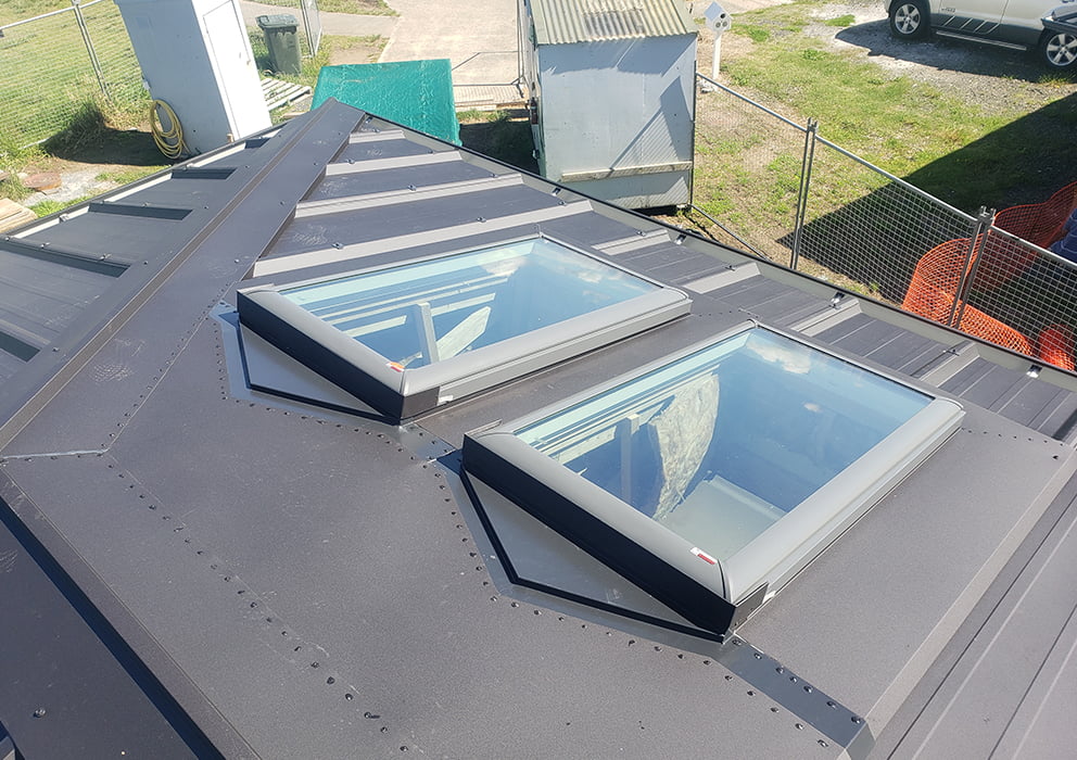 Two skylights on a long run roof of a new build house.