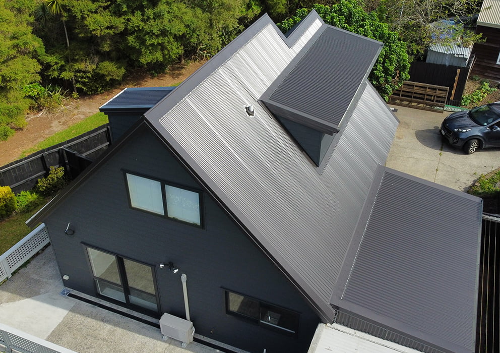 A new angled black long run roof on a residential property.