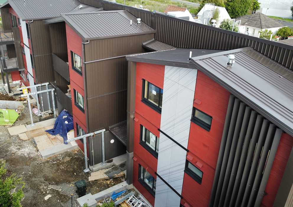 New steel roofing on a new build apartment complex with spouting and gutters.