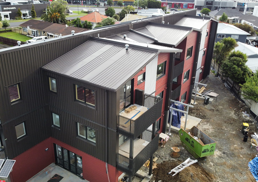 Photograph of new steel roofing on an apartment block.