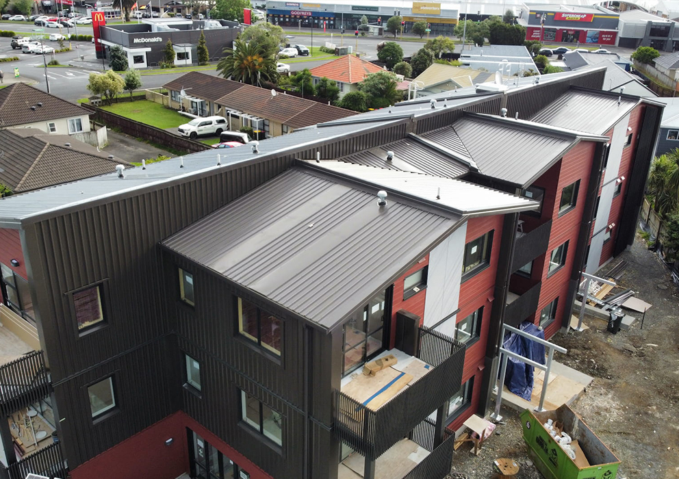 Large new apartment complex with new steel roof and guttering.