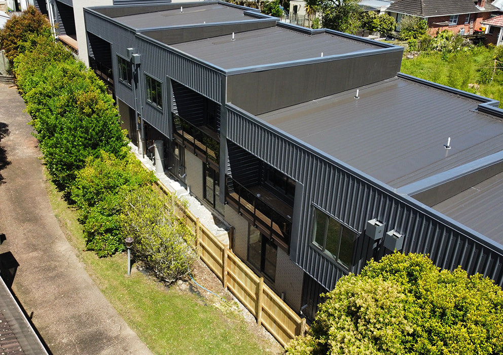 Photo of residential units with coloursteel roofing.