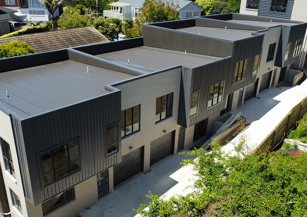 Residential new build units with steel roofing and guttering.
