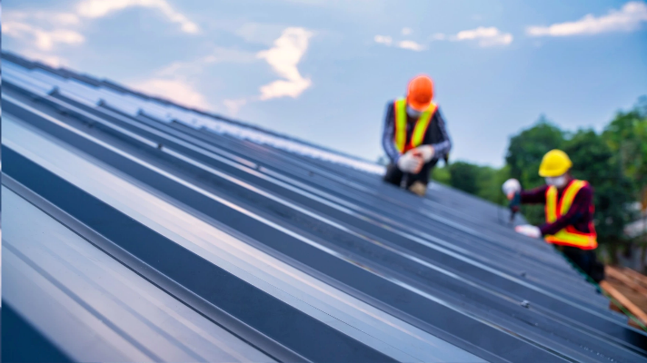 How Much Does a New Roof Increase Home Value – Workers on a New Roof